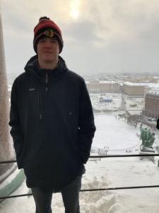 Ethan Sargent in front of a snowy Moscow cityscape.