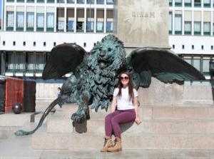 Marianna Sbordone in front of winged lion statue.